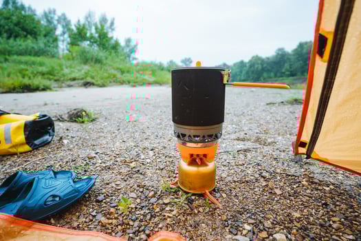 A cozy tent equipped with a reliable stove is truly perfect for cooking meals and warming up food, significantly enhancing the overall comfortable and enjoyable outdoor experience photo