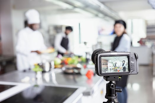 Diverse cooking professionals recording a web master class tutorial, demonstrating food preparation and plating techniques. Vlogging session helping beginners from anywhere in the world. photo