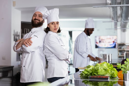 Team of gourmet chefs working together on a professional dish in the kitchen, uniting their cooking skills and creating a delicious gourmet meal for the restaurant menu. Fine dining. photo