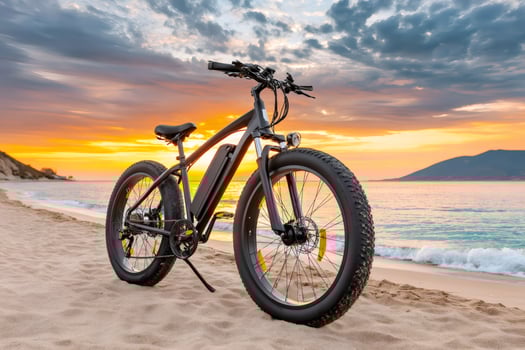 Fat tire electric bicycle enjoying golden sunset on sandy beach photo