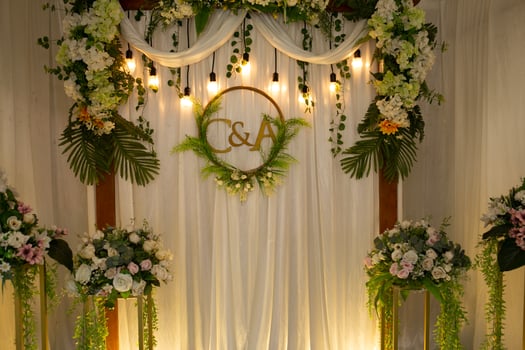 a wedding ceremony with flowers and greenery photo