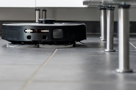 Robot vacuum cleaner with dust, real life photo, saves time and goes into hard-to-reach places photo