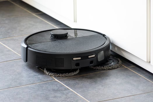 Robot vacuum cleaner with dust, real life photo, saves time and goes into hard-to-reach places, dusty photo