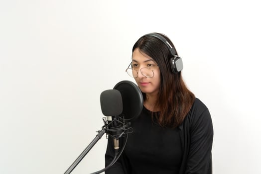 A woman in headphones and a microphone photo