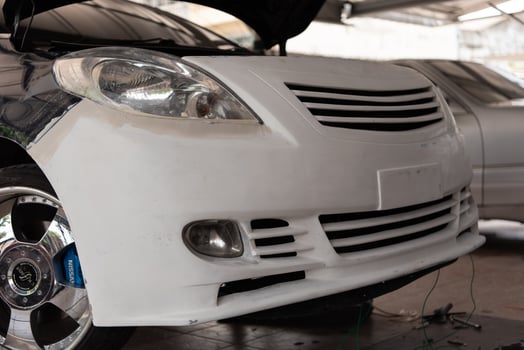 A white car with a hood up photo