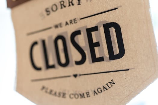 A sign hanging off coffee shop door. photo