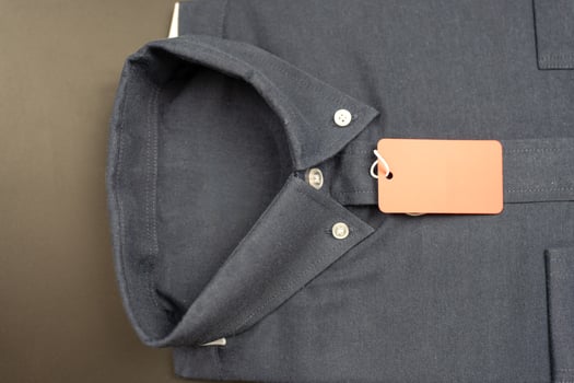Classic folded dark blue clothes with a red paper tag photo