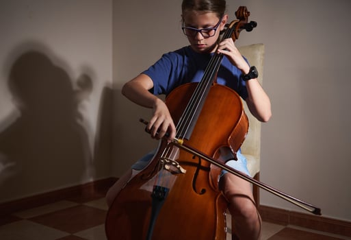Young Musician Practicing the Cello in a Peaceful Indoor Setting photo