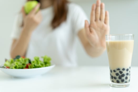 Diet and dieting. Beauty slim female body confuse sweet juice. Woman in exercise clothes achieves weight loss goal for healthy life, crazy about thinness, thin waist, nutritionist. photo