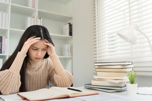 Asian student woman have anxiety because of exams, female prepare for test and learning lessons in the library. stress, despair, haste, misunderstanding reading, discouraged, expectation, photo