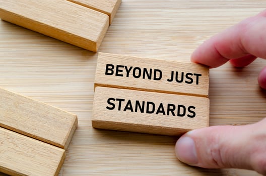 Beyond just standards text on wooden blocks in hand highlights action and truth beyond mere statements photo
