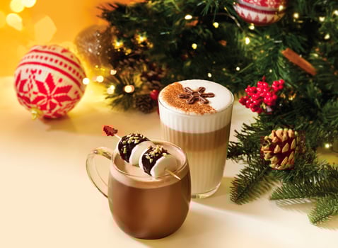 Cozy Hot Chocolate with Rocky Road Marshmallows and Festive Ginger Latte Macchiato with Chocolate Snowflake topped with rich frothy milk served in glass mug assorted hot beverage photo