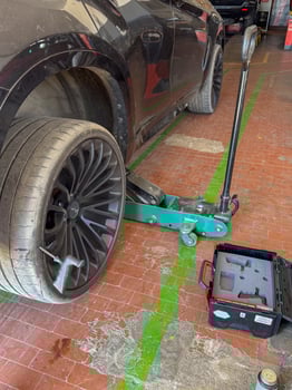 Car Tire Replacement Process with Jack Lift in Garage photo