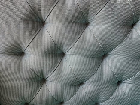 Close up of grey quilted leather upholstery texture background photo