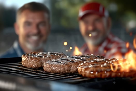 Two men are grilling steaks on a grill photo