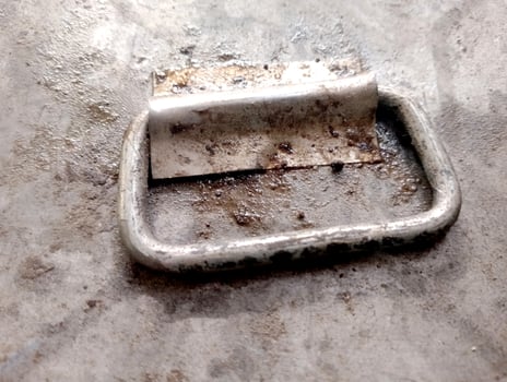 Close-up of a rusted metal handle on a weathered surface photo