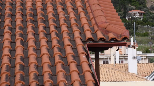 Rustic terracotta roof tiles covering traditional building in scenic neighborhood showcasing craftsmanship and architectural details during daylight hours photo