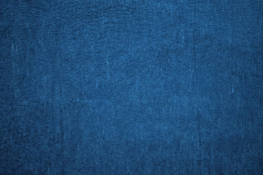 Deep blue textured background. Embossed wall with blue tones photo
