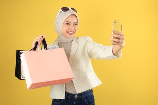 Young Asian Woman Selfie While Showing Off Her Paper Bag photo