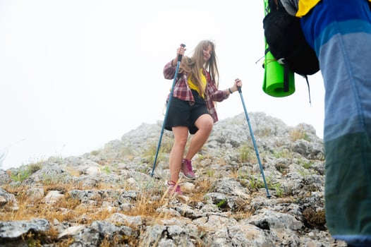 Hiking Adventure on a Rocky Mountain Trail During a Foggy Morning photo