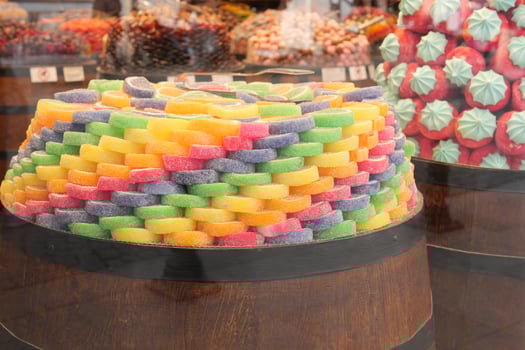 Colorful candy display in a market stall during daylight photo