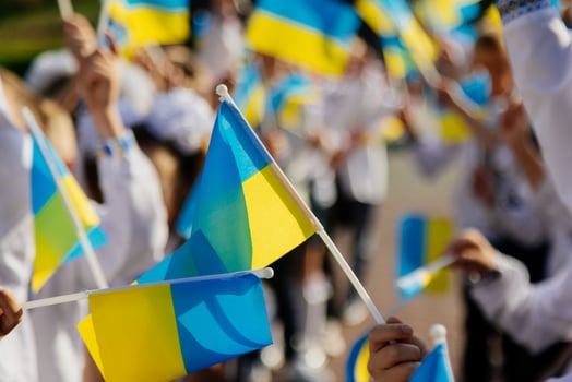 The concept of the young generation of Ukraine. Many Ukrainian children hold the yellow and blue flag in their hands. photo