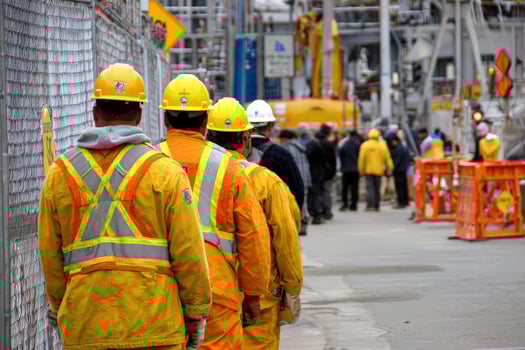 Group of construction workers walk toward a construction site photo