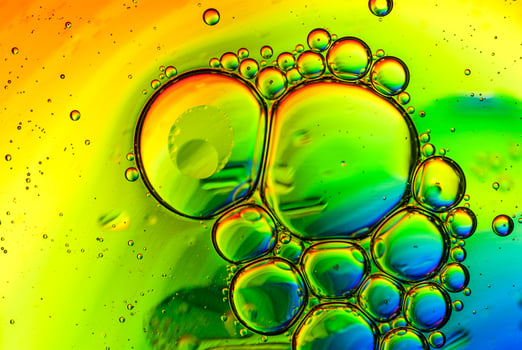 Oil and water bubbles in a rainbow colored background photo