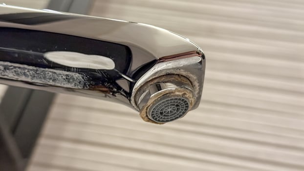 Glistening tarnished faucet, a metallic tale of neglect and limescale, echoing Water Conservation Days urgent whispers for change photo