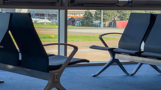 Silent airport chairs await travelers, reflecting anticipation and solitude, invoking Wanderlust Holiday and Solitude Day in transit photo