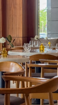 Ambient wooden cafe tables beckon intimate gatherings, echoing Earth Day serenity and World Design Days elegance with minimalist decor photo