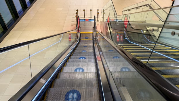 Silent escalators glide like futuristic carpets, echoing the nostalgia of Towel Day, whispers of urban exploration adventure photo