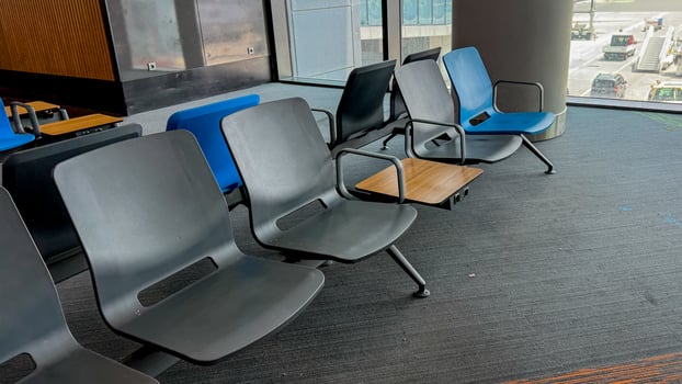Silent airport chairs patiently await wayward travelers, whispering tales of wanderlust and serendipitous layovers, evoking Travel Trivia Day photo