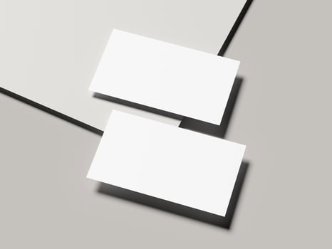 Angled pair of business cards with sharp shadow on light gray background photo