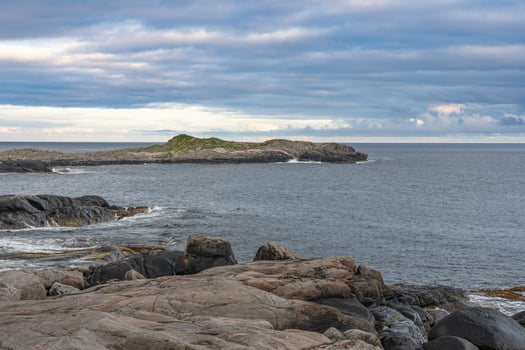 Rocky islands with waves crushing ocen view, Lofoten Norway photo