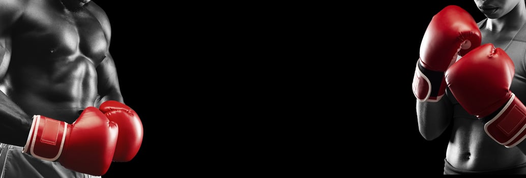 Monochrome photo of sporty afro man and woman in red boxing gloves over black background, free space for text between them, cropped, panorama, advertising for boxing studio