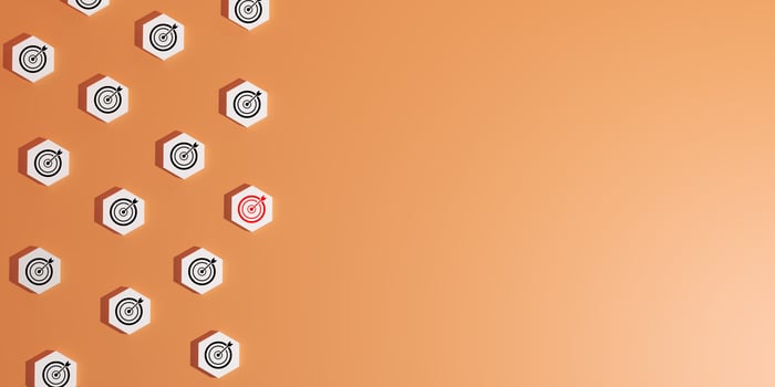 3D render of blocks with black and white target icons, featuring one distinct red target, set on orange background, symbolizing focused goals, strategic objectives, precision, identifying key targets. photo