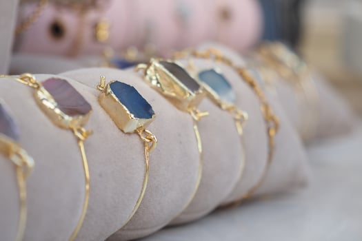 Colorful gemstone bracelets displayed at a craft market photo