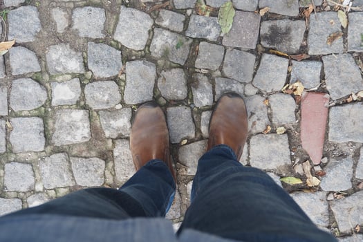 Walking on cobblestones while wearing brown boots photo