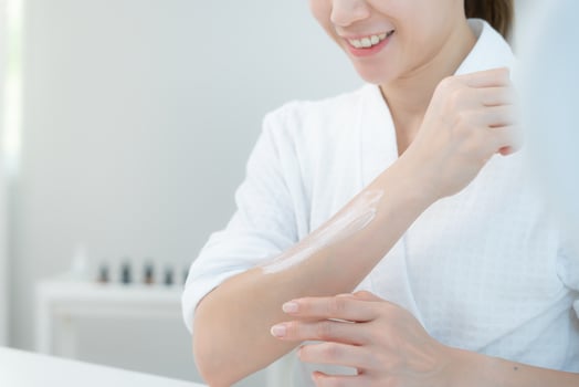 Beautiful Asian woman smile use cream for good skin. face of a healthy woman apply cream and makeup. Advertisement for skin cream, anti-wrinkle, baby face, whitening moisturizer tighten pores serum photo