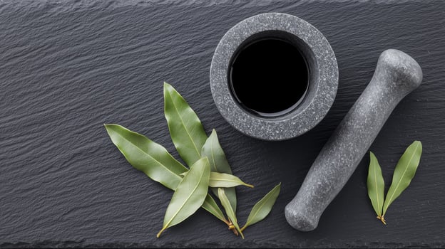 Dried bay leaves arranged on a dark slate surface, with a mortar and pestle nearby. 8 photo