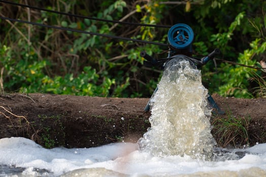 A man standing next to a water pipe photo