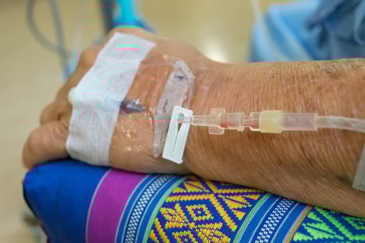 A person with an iv drip on their arm photo
