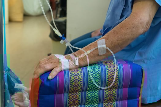 A person in a hospital room with an iv drip photo