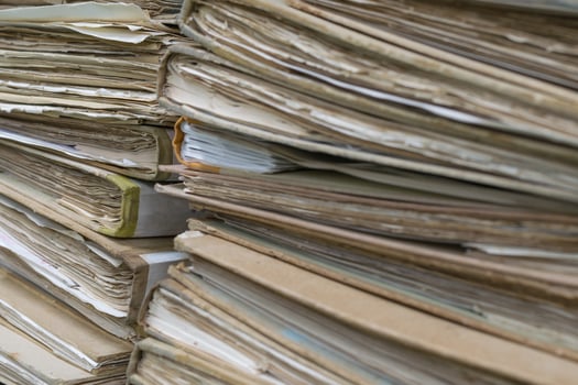 A pile of old documents sitting on top of each other photo