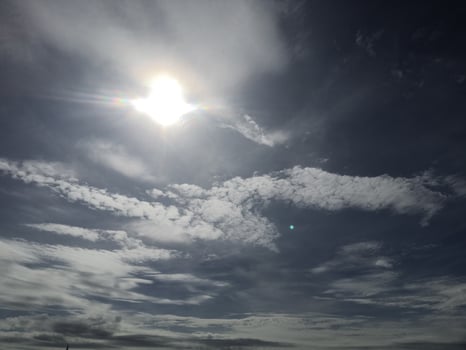 A person on a beach with a kite flying in the sky photo