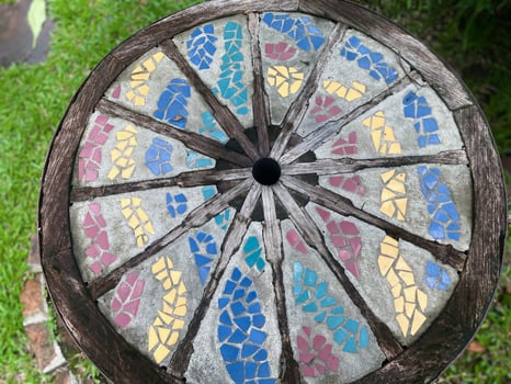 A colorful mosaic tile on a wooden table photo