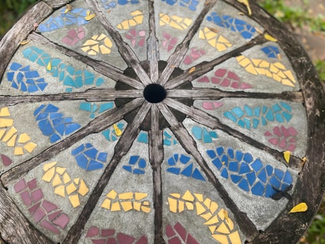 A colorful mosaic table with a hole in the middle photo