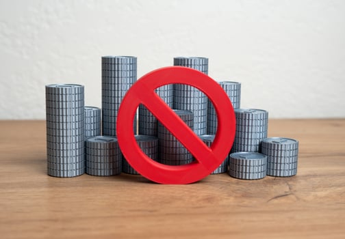 Money coins and a prohibition sign. Abandonment of metal denominations of the national currency. Monetary reform. Inflation control, currency redesign, or modern payment evolution. photo