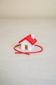 The house is circled with a red line. Select and inspect a house before purchasing. Inspection, legal verification, and securing a quality investment before purchase. photo